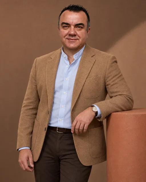 Stuart Newman in a camel blazer, studio portrait