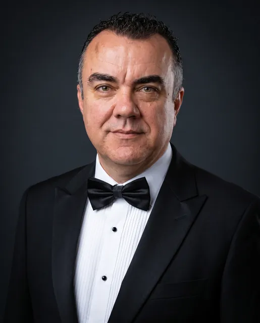 Stuart Newman in a black tuxedo and bow tie, formal portrait