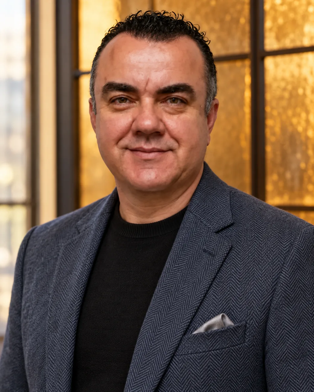 Stuart Newman Stuart Newman, Director of Strategic Growth and Partnerships, smiles while wearing a herringbone jacket.
